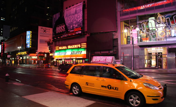 Yellow taxi parked along the road
