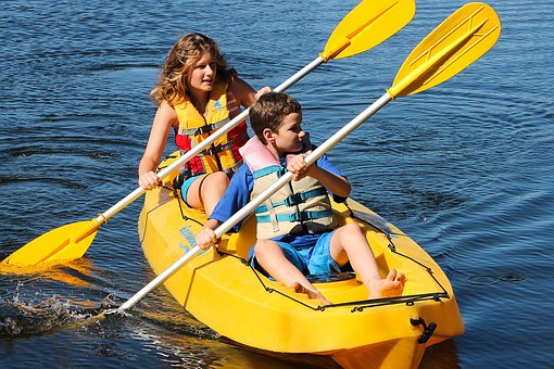 Kids riding on a two sitter kayak